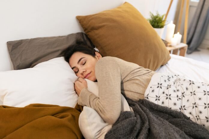 A woman sleeping peacefully in bed, wrapped in blankets and resting comfortably